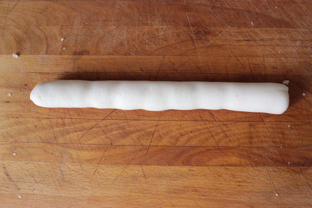 A rope of gluten-free dumpling dough