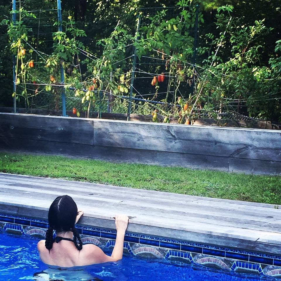Erin K Orr takes a break to swim and admire tomatoes at The Frieght. Photo by Rachael Shane http://rachaelshane.wix.com/rachaelshanephotography#!